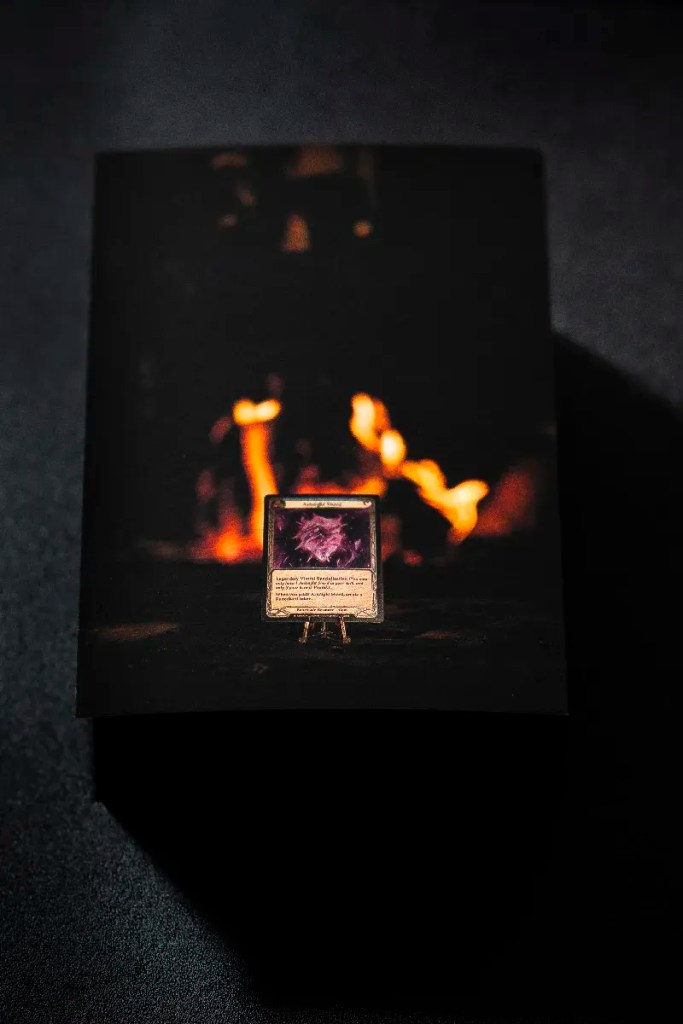 Fine Art Print 1/3 – a Living Provenance Relic – showing the Arknight Shard illuminated by the glowing forge fire.